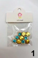Packaged decorative buttons with blue and gold colors on a white background