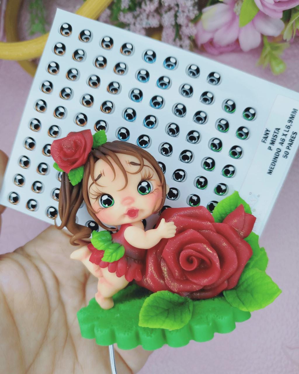 Decorative figurine of a girl with roses on a white card with black dots